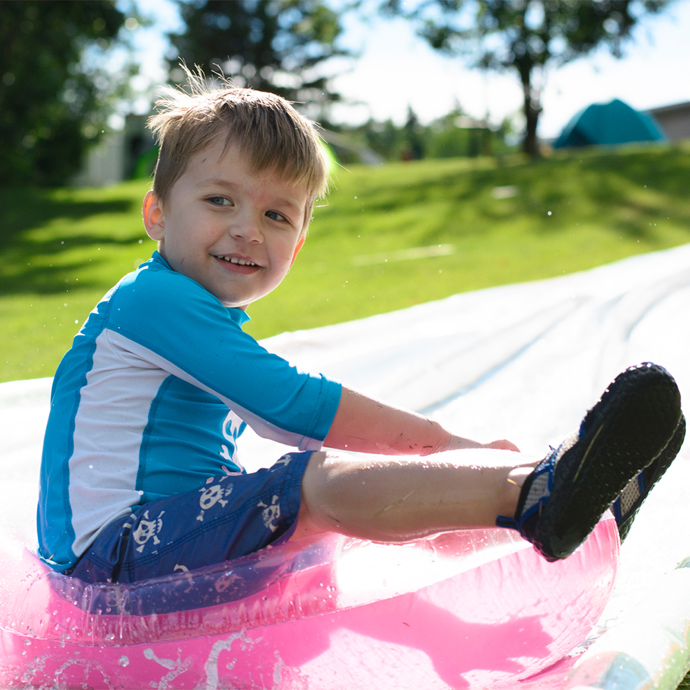 Photo of boy on slip and slide by Jessika Digital